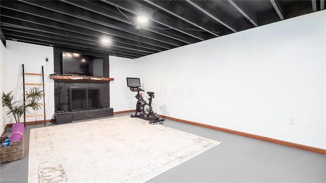 finished basement featuring baseboards and a fireplace