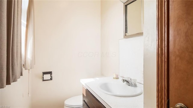 bathroom with toilet and vanity