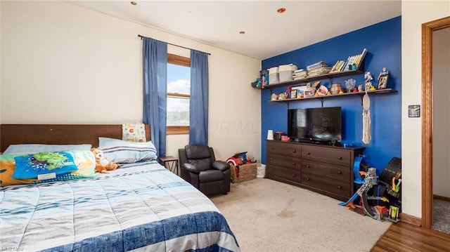 bedroom with baseboards and wood finished floors