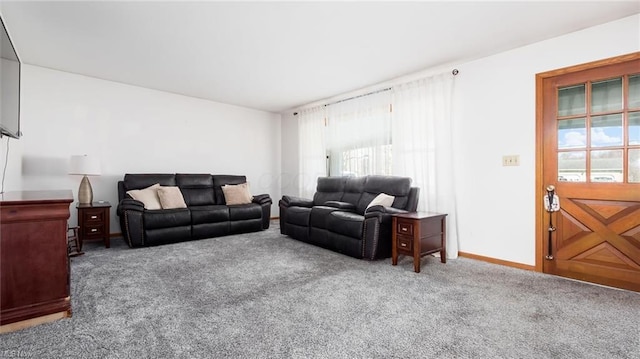 living room featuring carpet and baseboards
