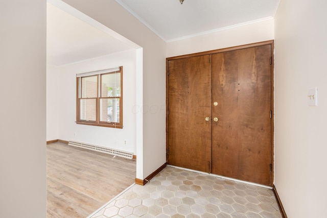 306 Northview Dr, London, OH 43140 - entryway with baseboards, a baseboard heating unit, ornamental molding, and light wood-style floors