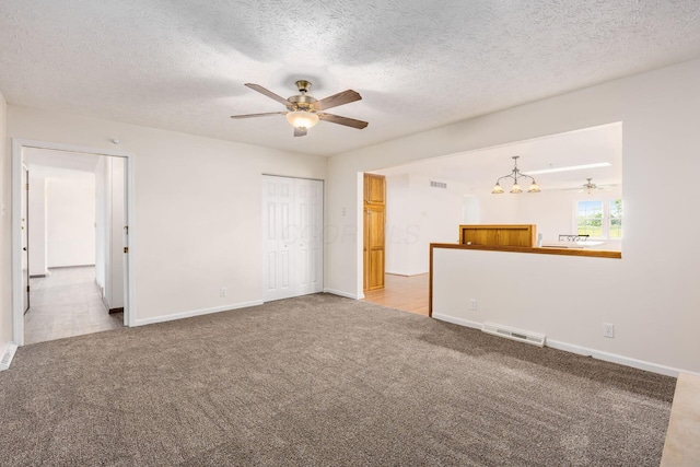 306 Northview Dr, London, OH 43140 - unfurnished living room with baseboards, visible vents, carpet, and ceiling fan with notable chandelier