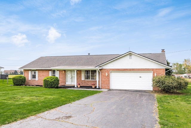 306 Northview Dr, London, OH 43140 - ranch-style house with an attached garage, roof with shingles, a front yard, brick siding, and driveway