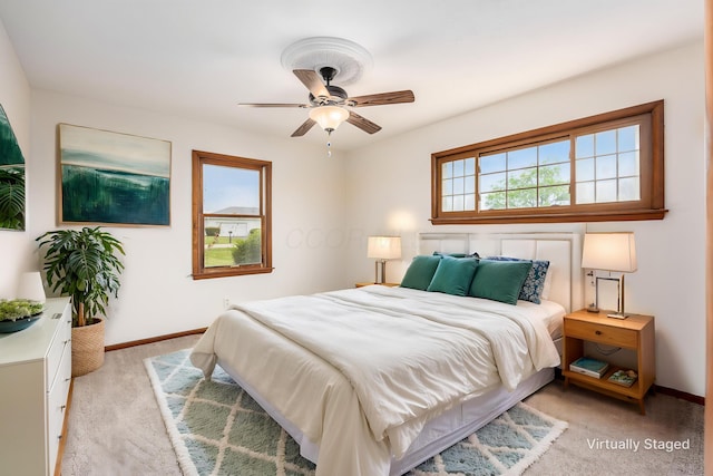 306 Northview Dr, London, OH 43140 - bedroom with light colored carpet, baseboards, ceiling fan, and multiple windows