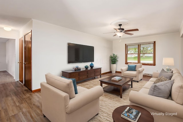306 Northview Dr, London, OH 43140 - living room featuring wood finished floors, baseboards, ceiling fan, a baseboard radiator, and ornamental molding