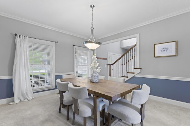 dining space with crown molding, baseboards, and carpet floors
