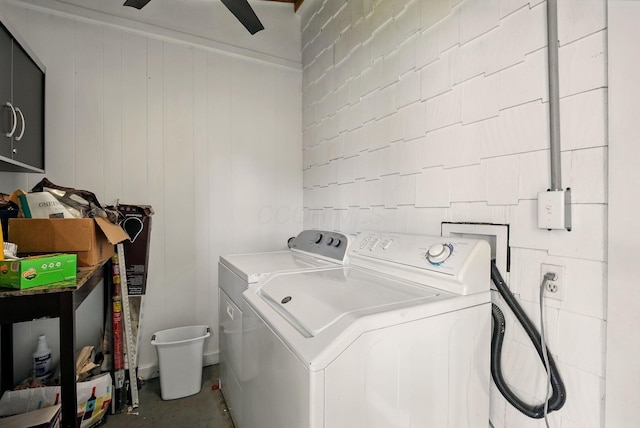 clothes washing area featuring separate washer and dryer and cabinet space