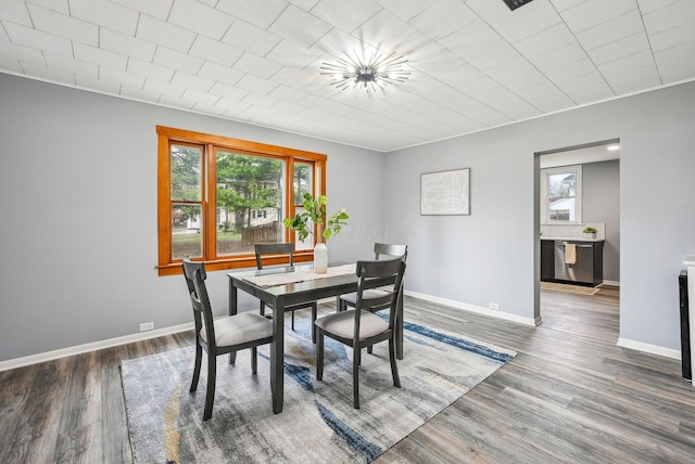 dining area featuring baseboards and wood finished floors
