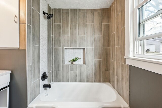 full bathroom with bathing tub / shower combination and a textured ceiling