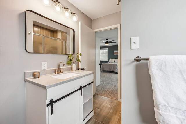 full bathroom with an enclosed shower, vanity, ensuite bath, wood finish floors, and ceiling fan