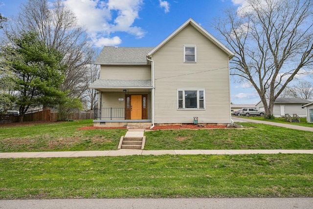 traditional home with a shingled roof, fence, a porch, and a front yard