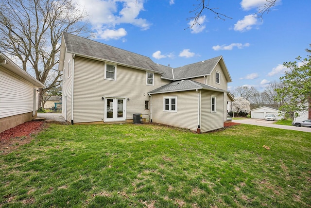 back of house featuring cooling unit, french doors, and a lawn