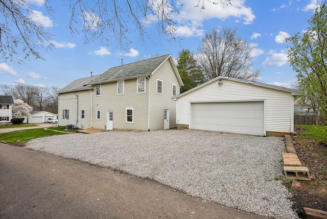 view of property exterior featuring fence, an outdoor structure, and a garage