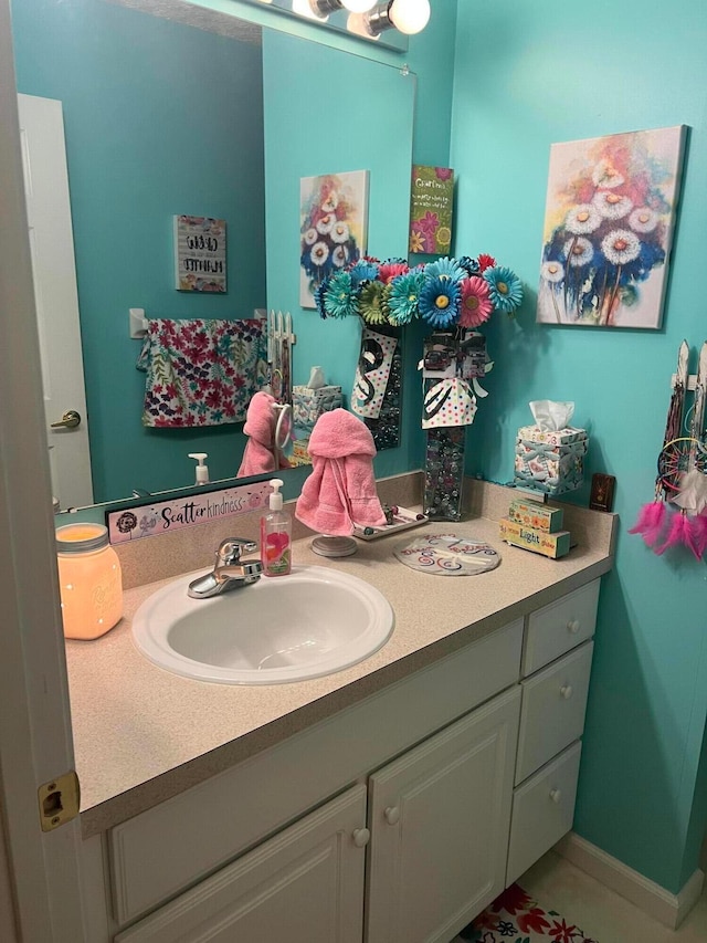 bathroom with vanity and baseboards