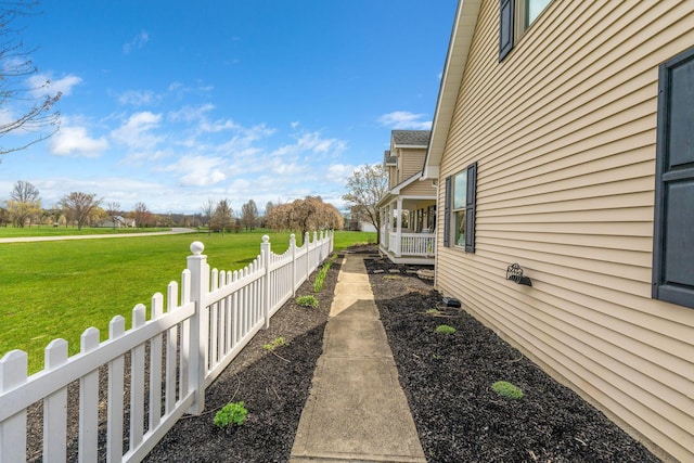 view of home's exterior with a yard and fence