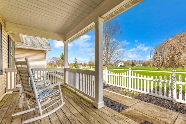 wooden deck featuring fence and a lawn