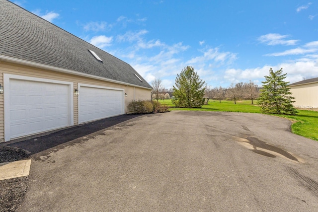 garage featuring aphalt driveway