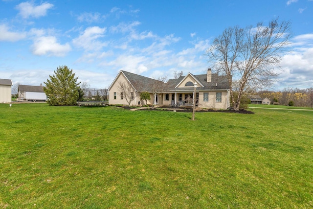 back of property featuring a yard and a chimney