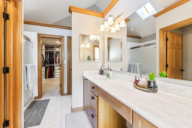 bathroom featuring crown molding, vaulted ceiling with skylight, tile patterned floors, and a stall shower