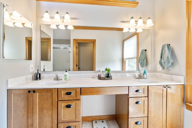 bathroom featuring a sink, an enclosed shower, and double vanity