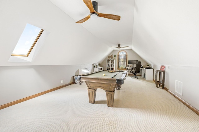 rec room featuring lofted ceiling with skylight, visible vents, light carpet, and ceiling fan