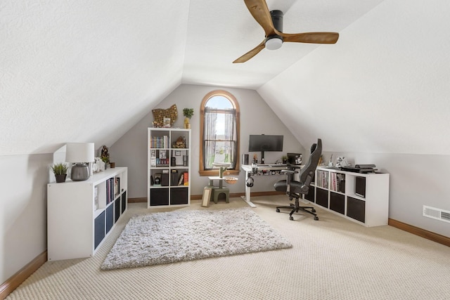 office with carpet, visible vents, baseboards, and vaulted ceiling