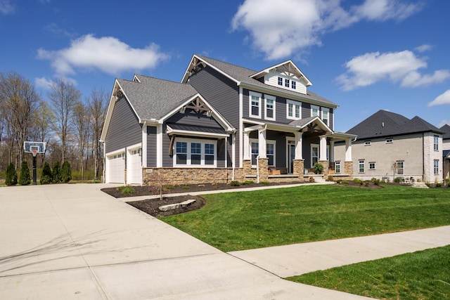 view of front of property with concrete driveway, stone siding, and a front lawn