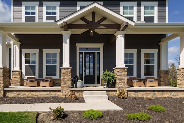view of exterior entry with a porch