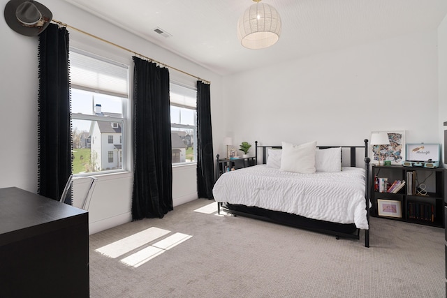 bedroom featuring light carpet and visible vents
