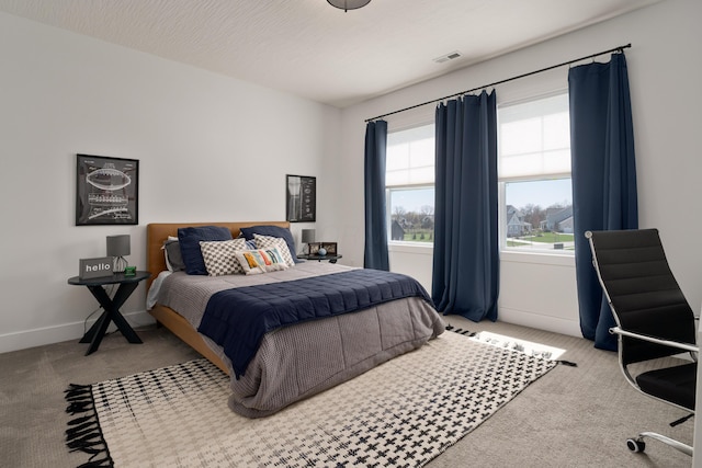 bedroom featuring carpet, visible vents, and baseboards