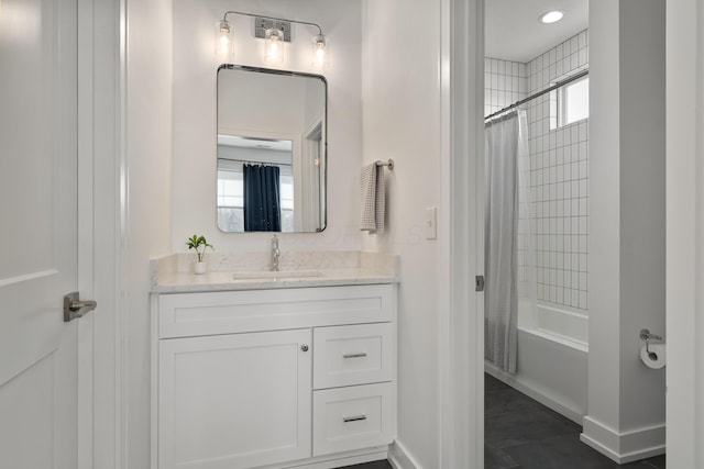 bathroom with baseboards, plenty of natural light, and vanity