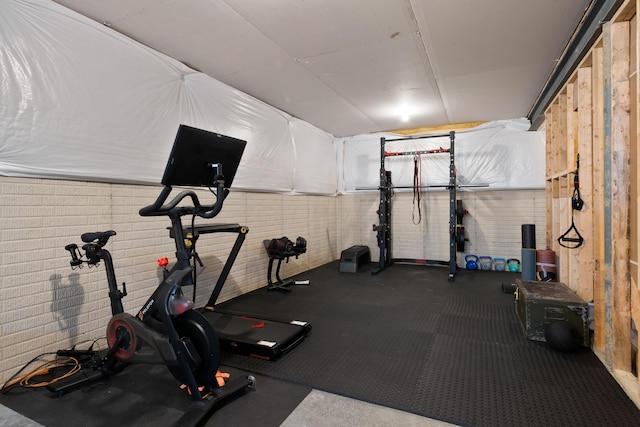 exercise area featuring brick wall