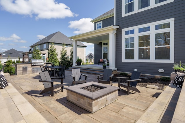 view of patio / terrace featuring an outdoor fire pit, an outdoor kitchen, and area for grilling