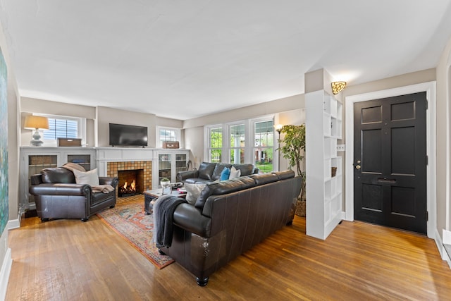 living room with wood finished floors and a fireplace