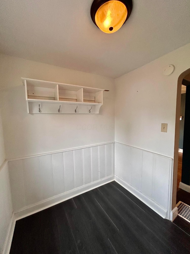 742 S Cassingham Rd, Bexley, OH 43209 - mudroom featuring arched walkways, dark wood-style flooring, and wainscoting