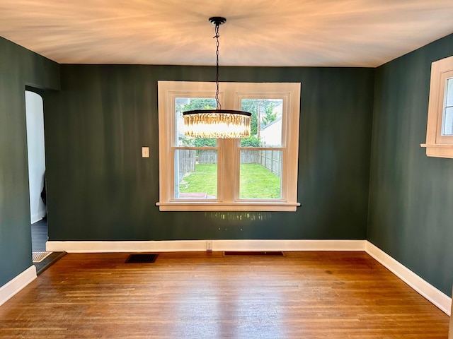 742 S Cassingham Rd, Bexley, OH 43209 - unfurnished dining area featuring a chandelier and wood finished floors