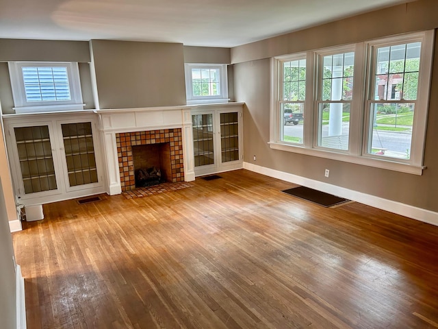 742 S Cassingham Rd, Bexley, OH 43209 - unfurnished living room featuring wood finished floors and a tile fireplace