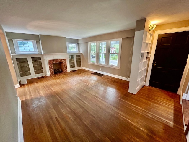 742 S Cassingham Rd, Bexley, OH 43209 - unfurnished living room with wood finished floors and a fireplace