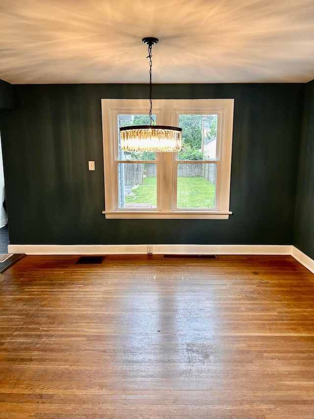 742 S Cassingham Rd, Bexley, OH 43209 - spare room featuring wood finished floors and a chandelier