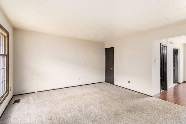 carpeted spare room with visible vents