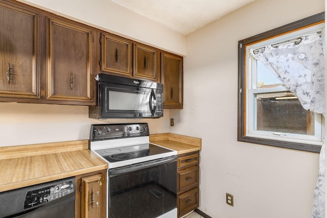kitchen featuring black appliances and light countertops