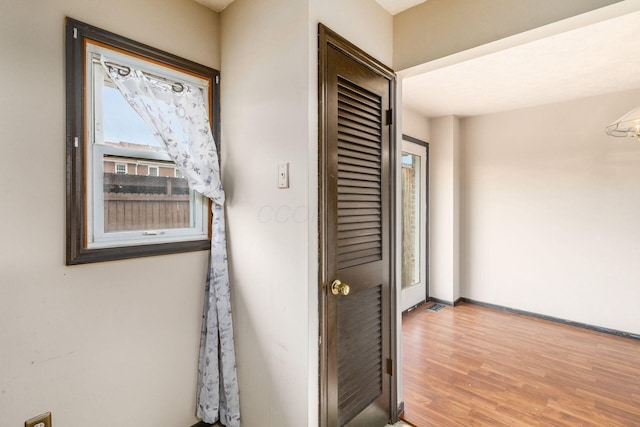 interior space featuring baseboards and wood finished floors