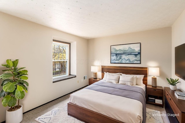 carpeted bedroom with baseboards and visible vents