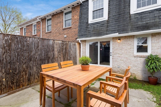 view of patio featuring fence and outdoor dining space