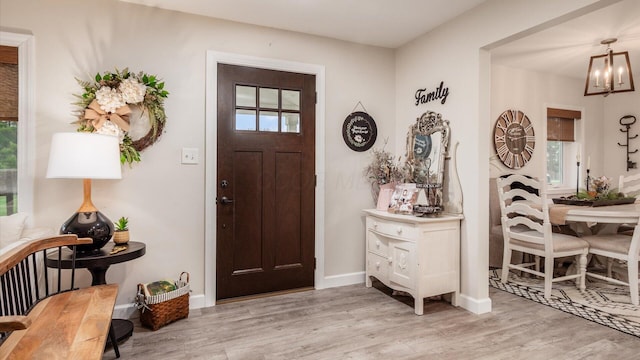 5456 Skyline Dr, Cambridge, OH 43725 - foyer entrance with an inviting chandelier, light wood-type flooring, and plenty of natural light