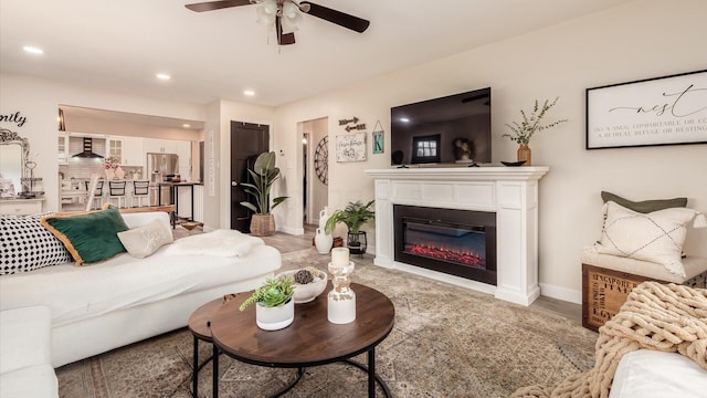 5456 Skyline Dr, Cambridge, OH 43725 - living area featuring baseboards, recessed lighting, a glass covered fireplace, and a ceiling fan