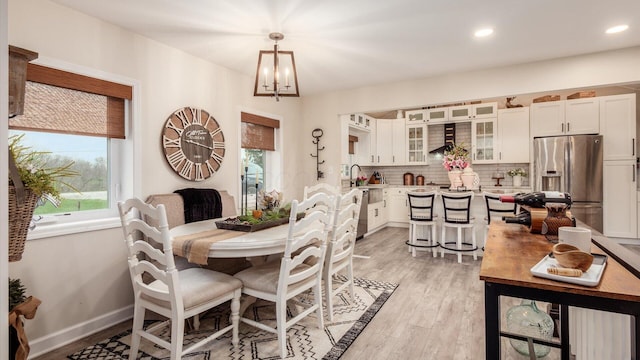 5456 Skyline Dr, Cambridge, OH 43725 - dining space with baseboards, light wood-style floors, a chandelier, and recessed lighting
