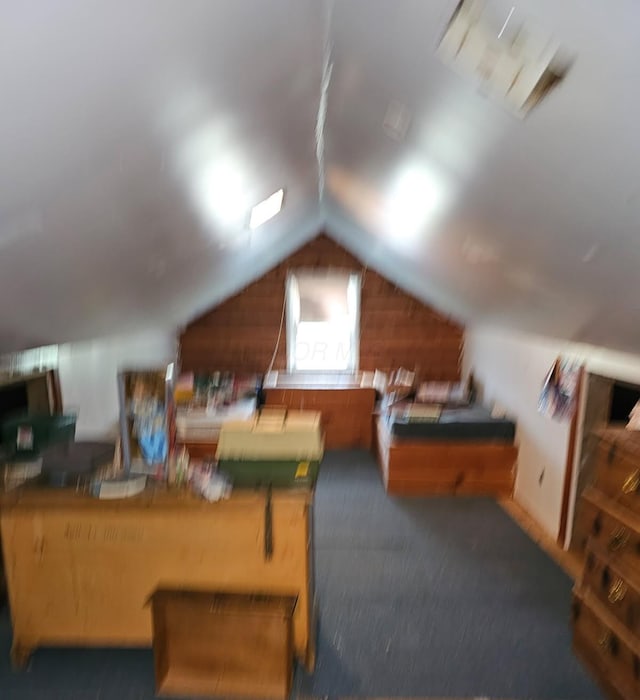 interior space featuring carpet flooring and lofted ceiling