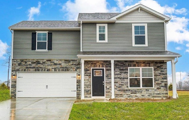 view of front facade with stone siding, a front yard, concrete driveway, and a garage