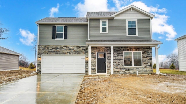 traditional-style house featuring stone siding, driveway, and a garage